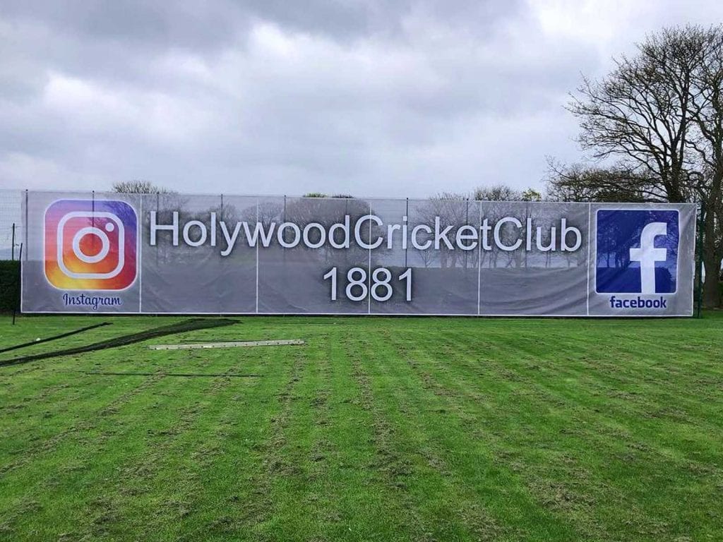 A mesh banner correctly hung onto fencing