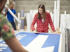 a woman checking over her new vinyl banner